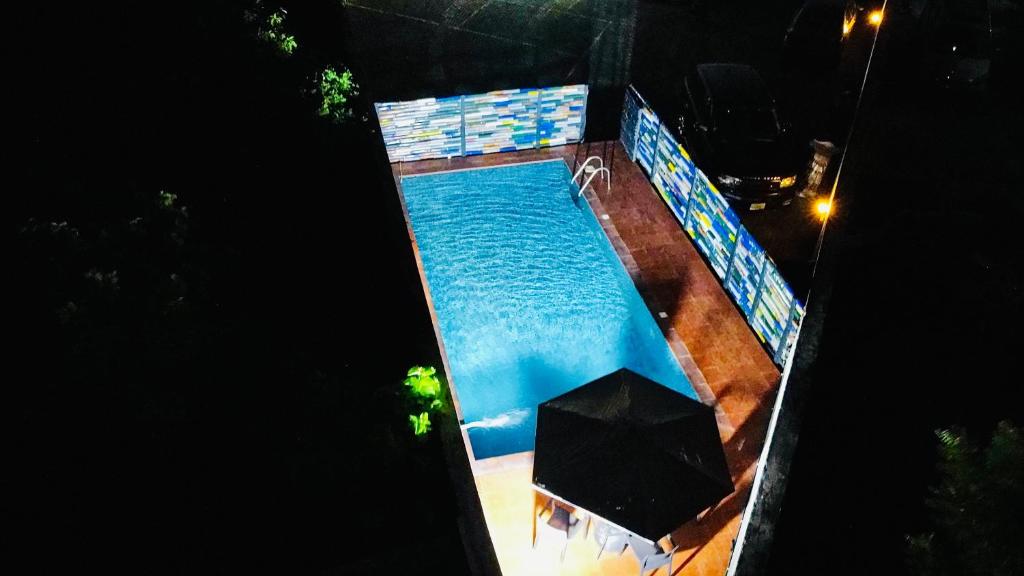 an overhead view of a swimming pool at night at The Zen Loft - 2BR Open Plan Apt W/Pool+Smart Lock in Lekki