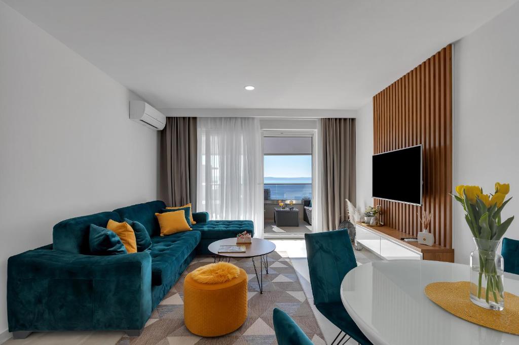 a living room with a blue couch and a table at Apartment Angels Makarska in Makarska