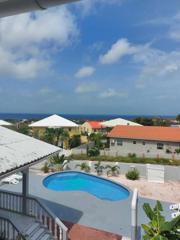 a view of a swimming pool from the balcony of a resort at Villa Raven`s Paradise (Gris) in Willemstad