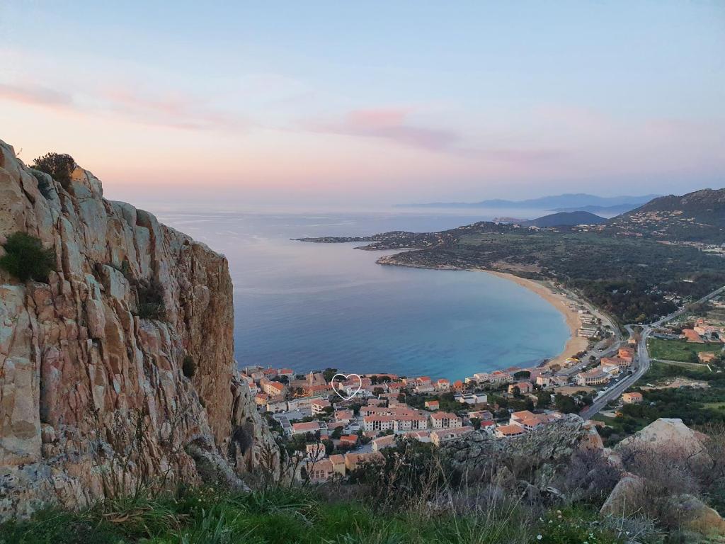 a view of a city from a cliff at Casa Orfea in Algajola