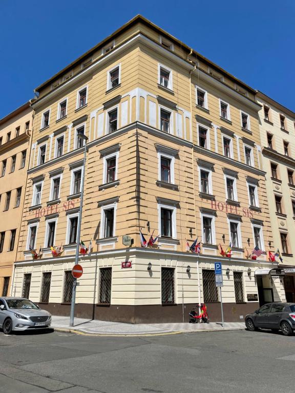 a large building with american flags on the side of it at Gallery Hotel SIS in Prague