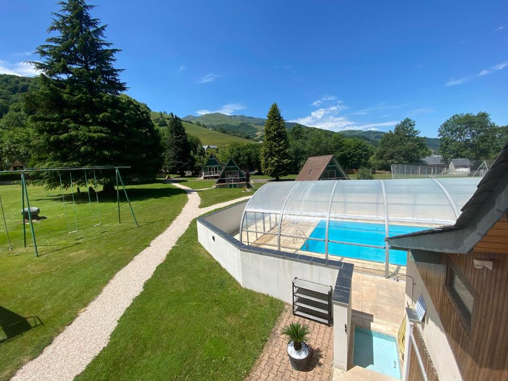 an overhead view of a house with a swimming pool at Hotel Le Chalet in Sainte-Marie-de-Campan