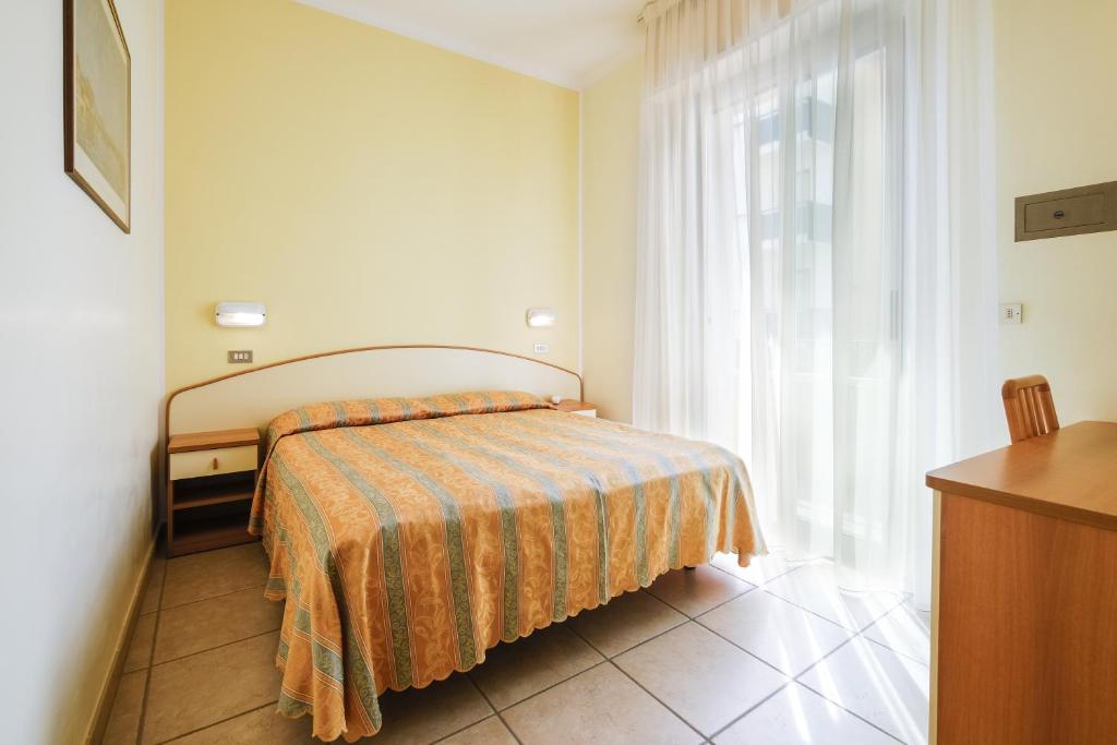 Postel nebo postele na pokoji v ubytování Hotel Thea