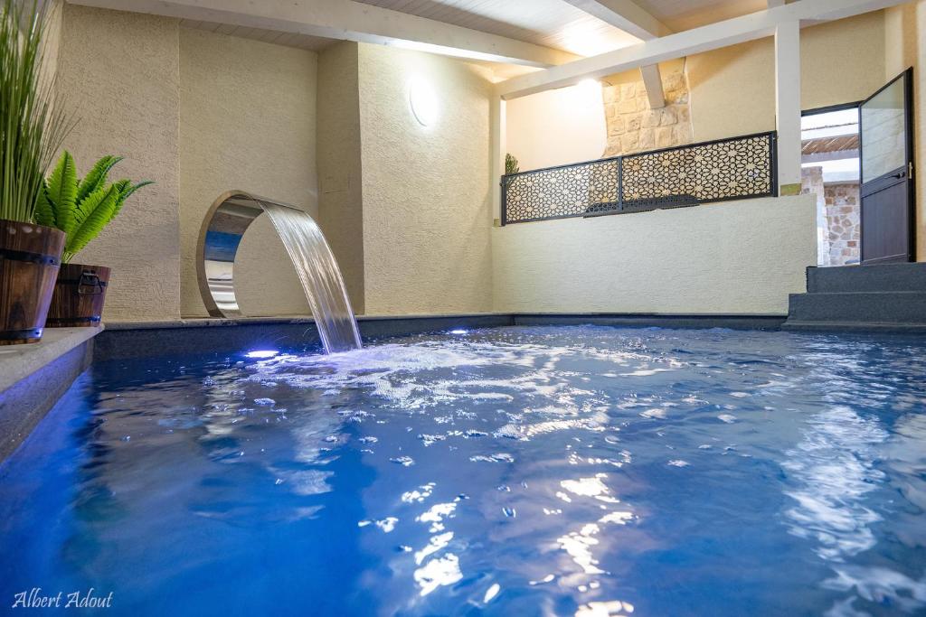 a swimming pool with a fountain in a house at מלכה בעתיקה in Safed