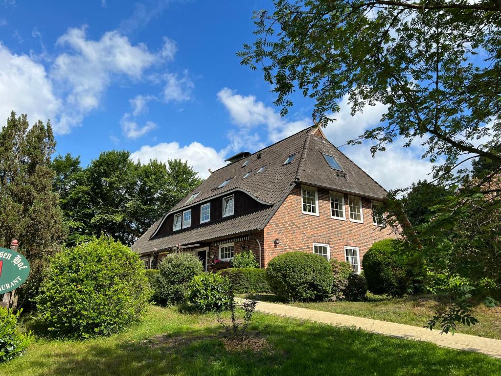 a red brick house with a gambrel roof at Niedersachsen Hof in Bispingen