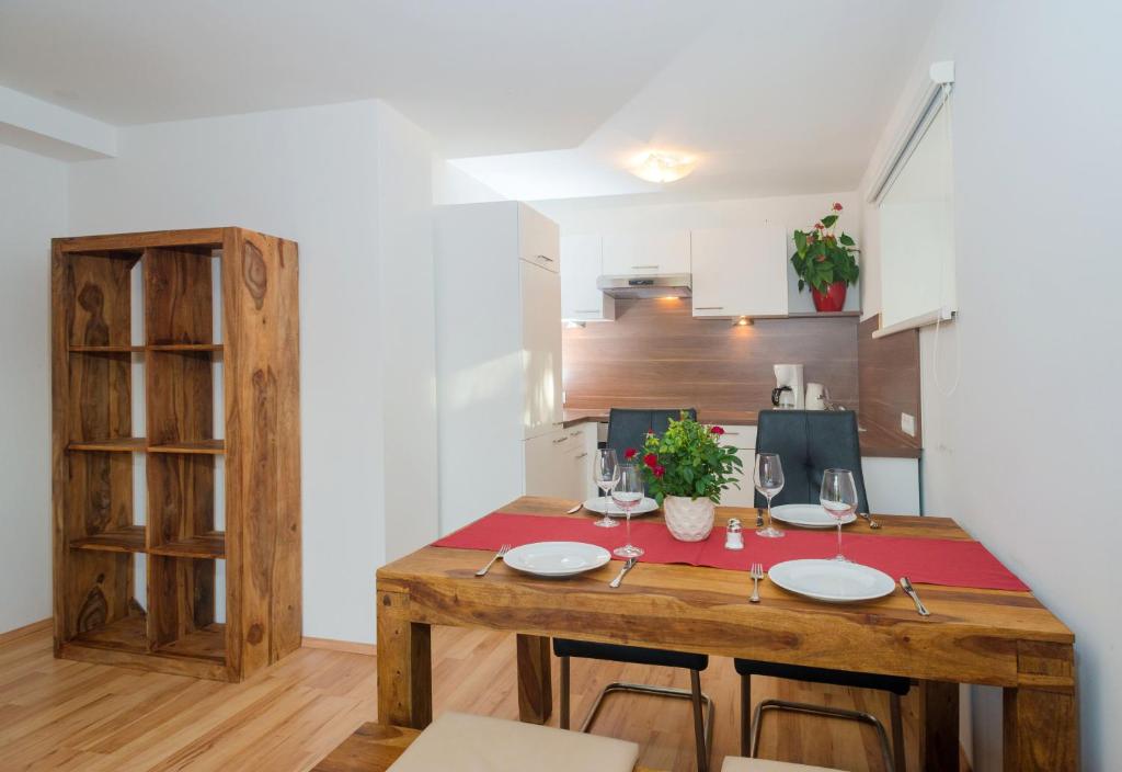 a kitchen with a wooden table in a room at Apartment Eisl in Ramsau am Dachstein
