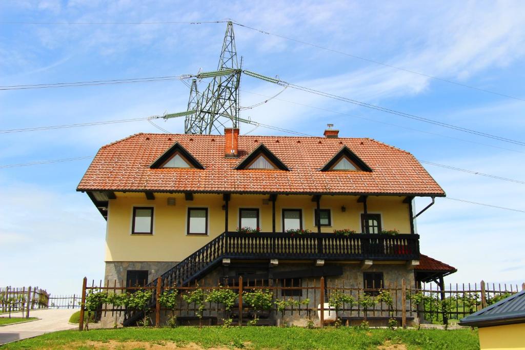 a house with a roof on top of it at Apartments Jožetov grič - FARM STAY in Podčetrtek