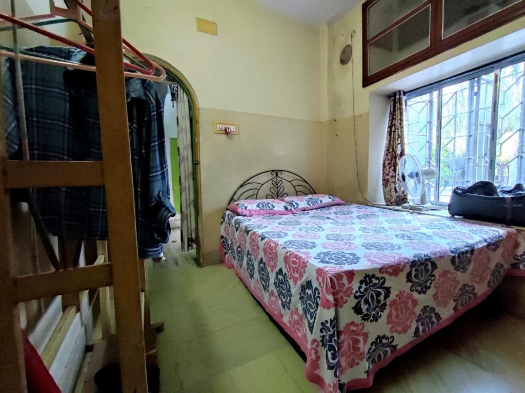 a bedroom with a bed in a room with a ladder at Peaceful Living in Kolkata