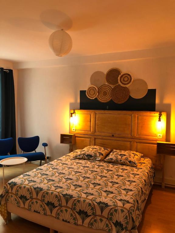 a bedroom with a large bed and two chairs at L'étape II in Varzy