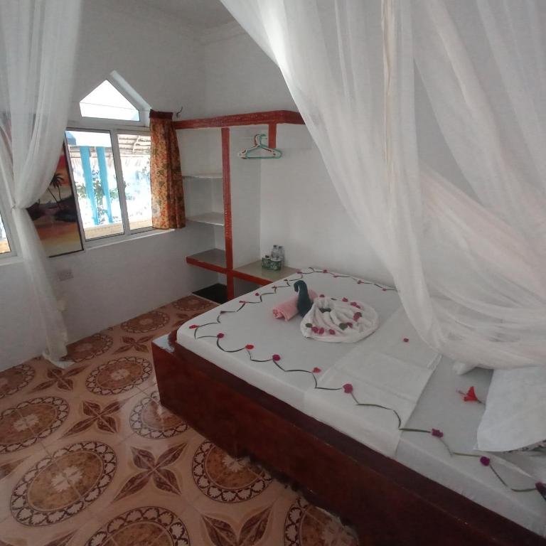 Postel nebo postele na pokoji v ubytování Mudi House