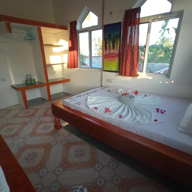 Postel nebo postele na pokoji v ubytování Mudi House