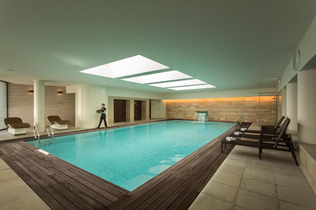 a pool with a person standing in the middle of it at Hotel Dom Goncalo & Spa in Fátima