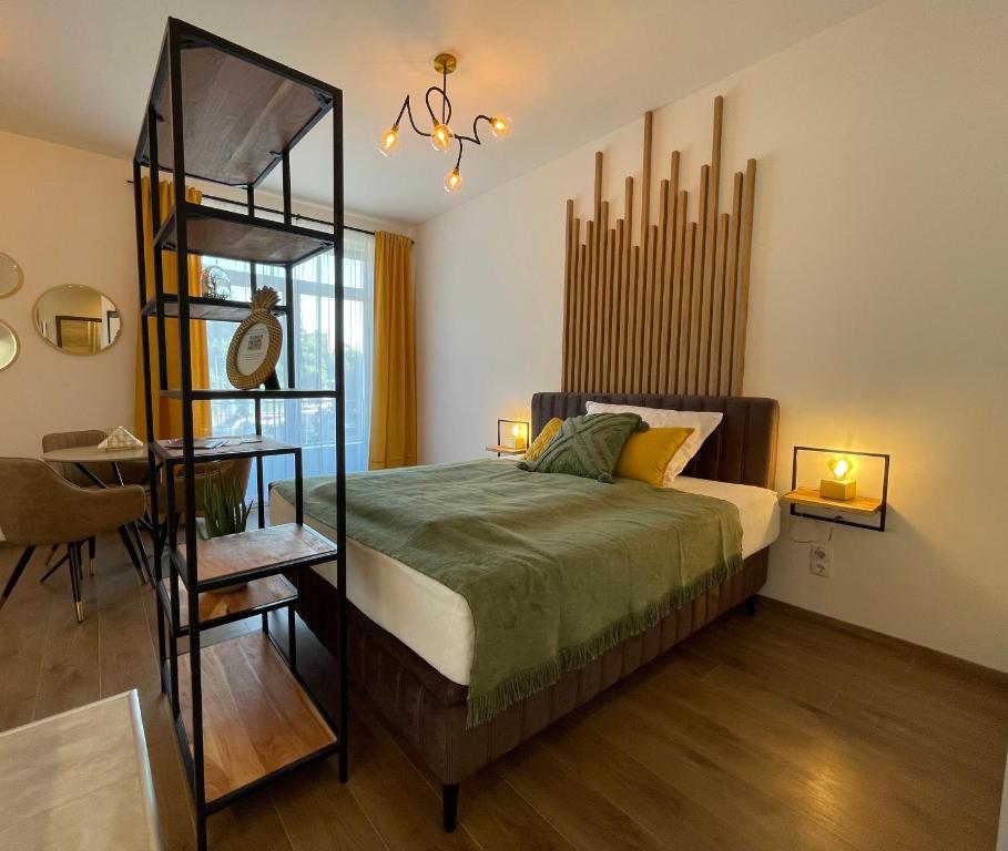 a bedroom with a bed with a wooden floor at Hillside Central Apartments in Budapest
