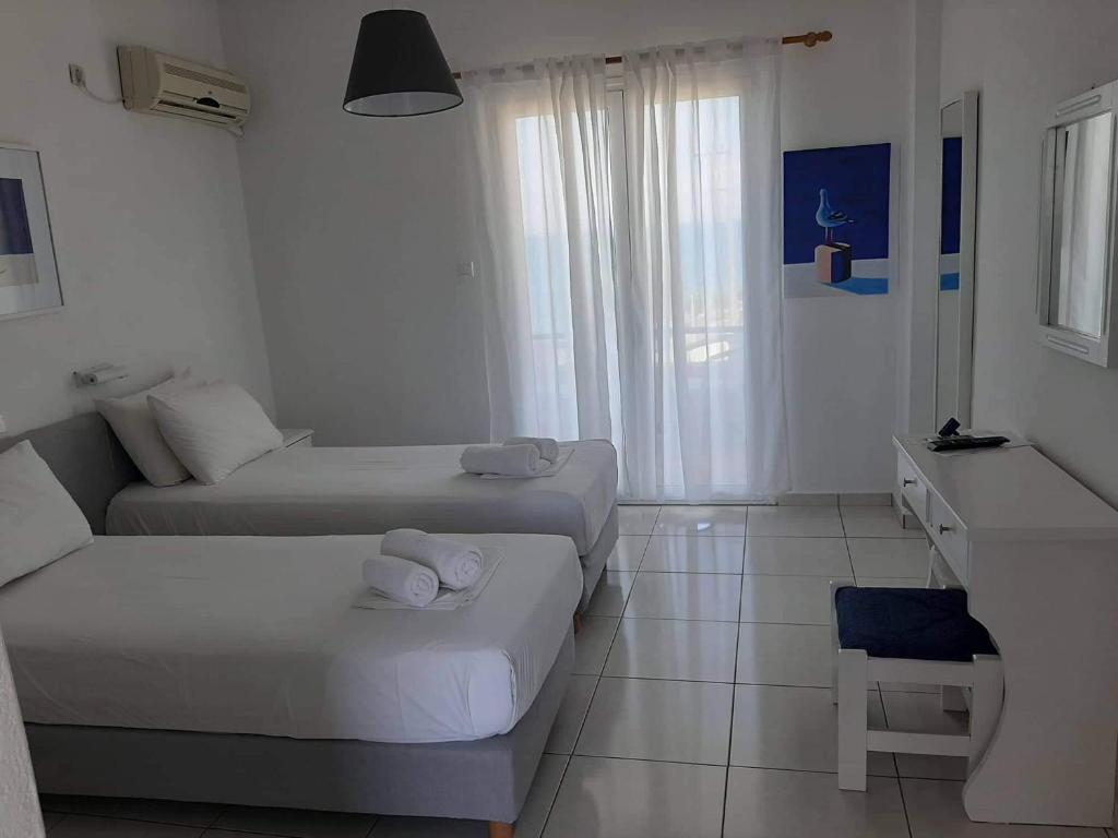Postel nebo postele na pokoji v ubytování Seaside Studios
