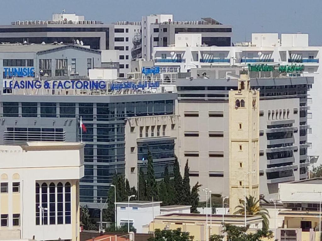 a group of buildings in a city with at jolie appart au centre urbain nord in Tunis