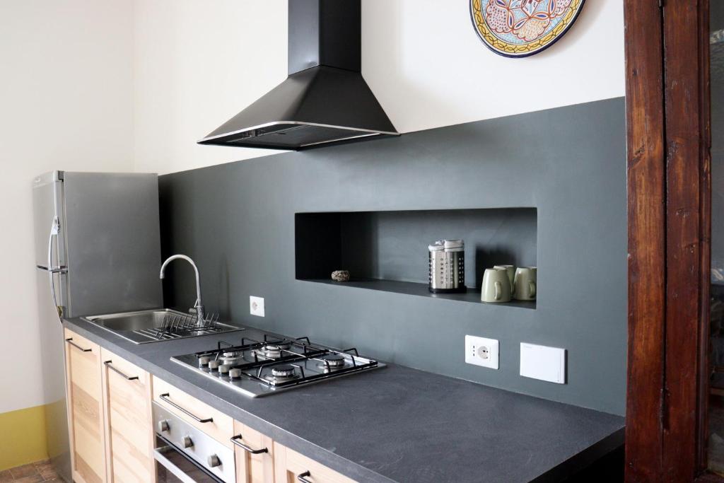 a kitchen with a sink and a stove top oven at Agriturismo Morani in Santa Severa