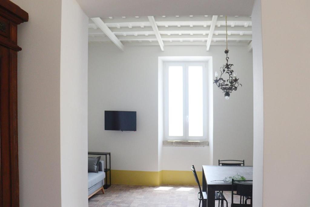 a dining room with a table and a window at Agriturismo Morani in Santa Severa