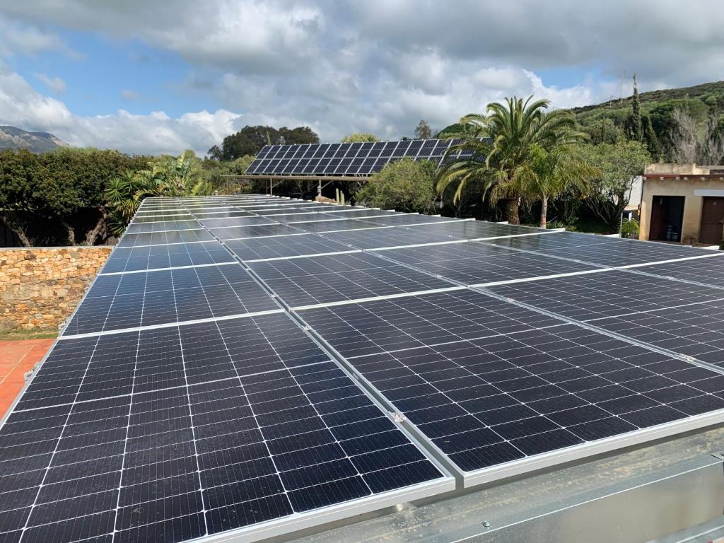 a group of solar panels on top of a roof at Dulce Nombre Hotel - Apartamentos in Tarifa