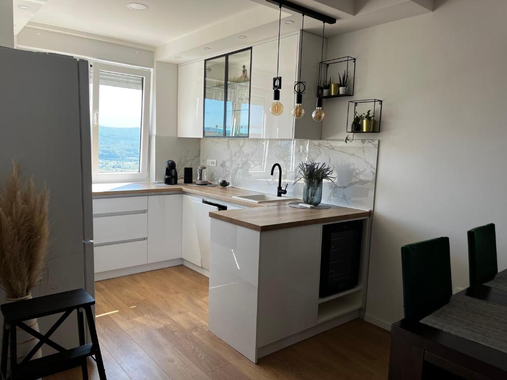 een keuken met witte kasten en een raam bij Central apartment/free parking/free wifi in Imotski