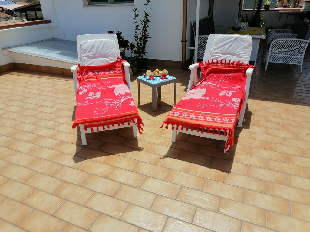 トラッペートにあるCasa del Soleの赤いクッション付きの椅子2脚、テーブルが備わる客室です。