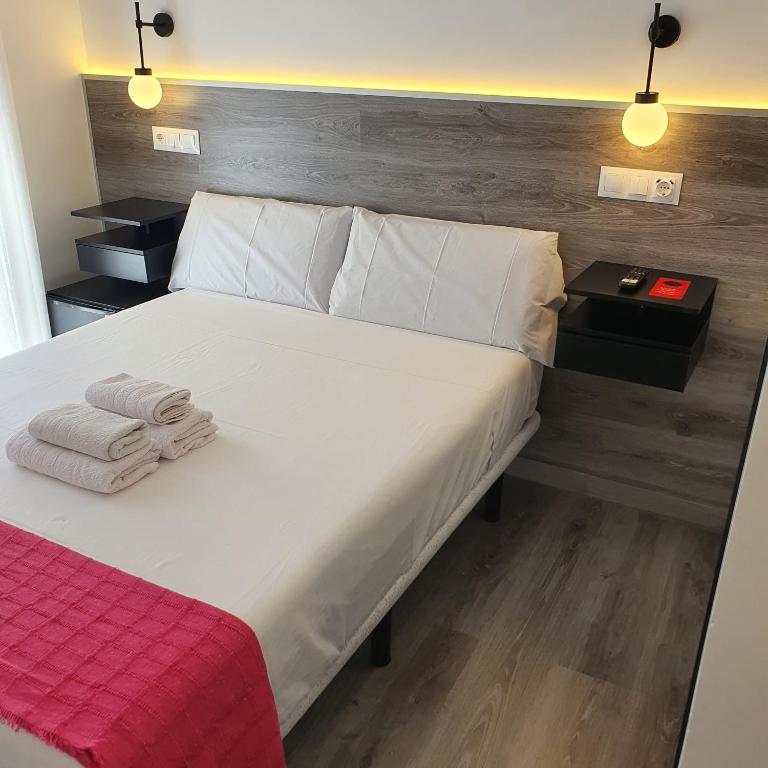 Postel nebo postele na pokoji v ubytování CH Bueno