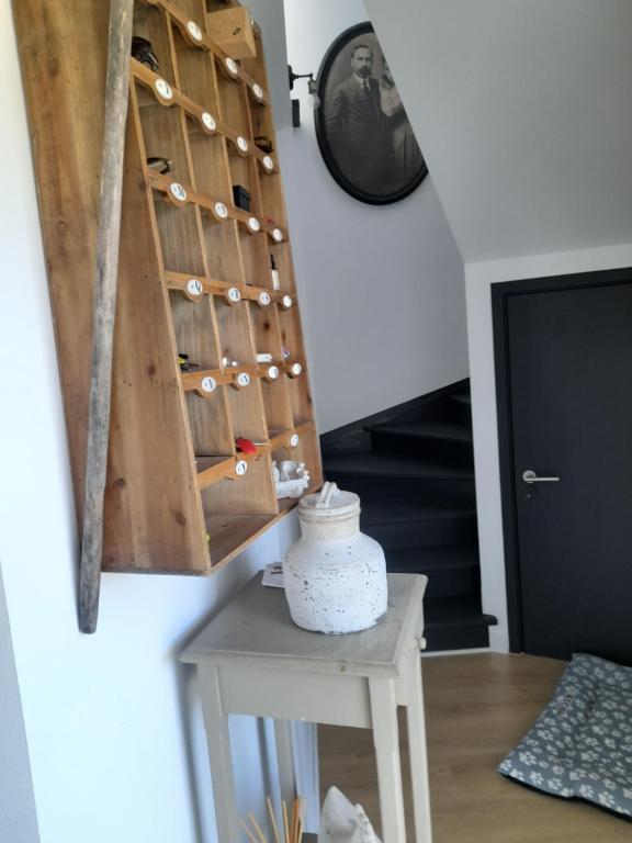 a room with a wooden wine rack and a table at Villa Alegria in Ericeira