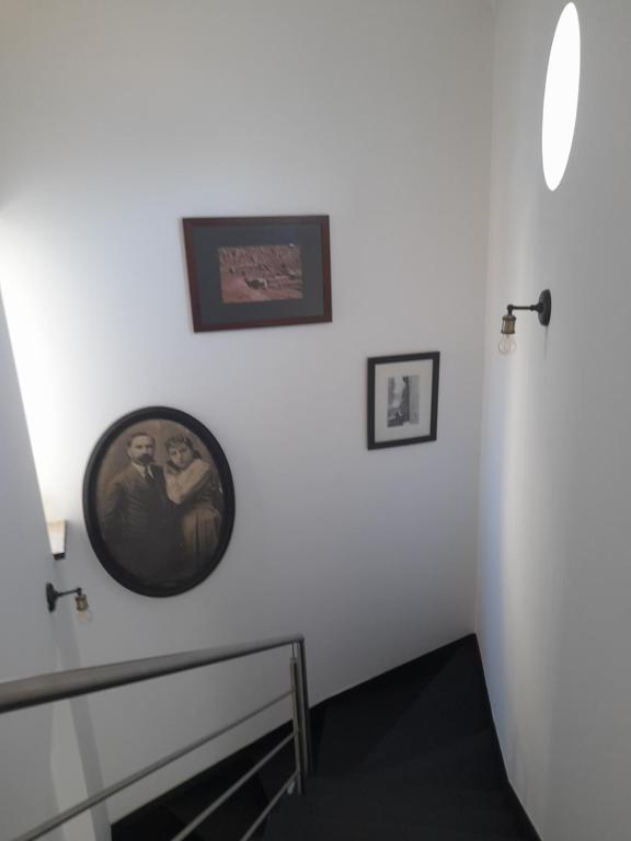 a hallway with two pictures on a white wall at Villa Alegria in Ericeira