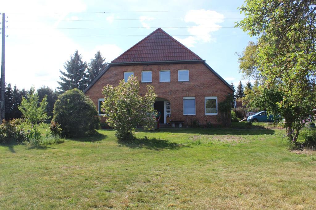 a large brick house with a pitched roof at Landperle Darze in Altenhof
