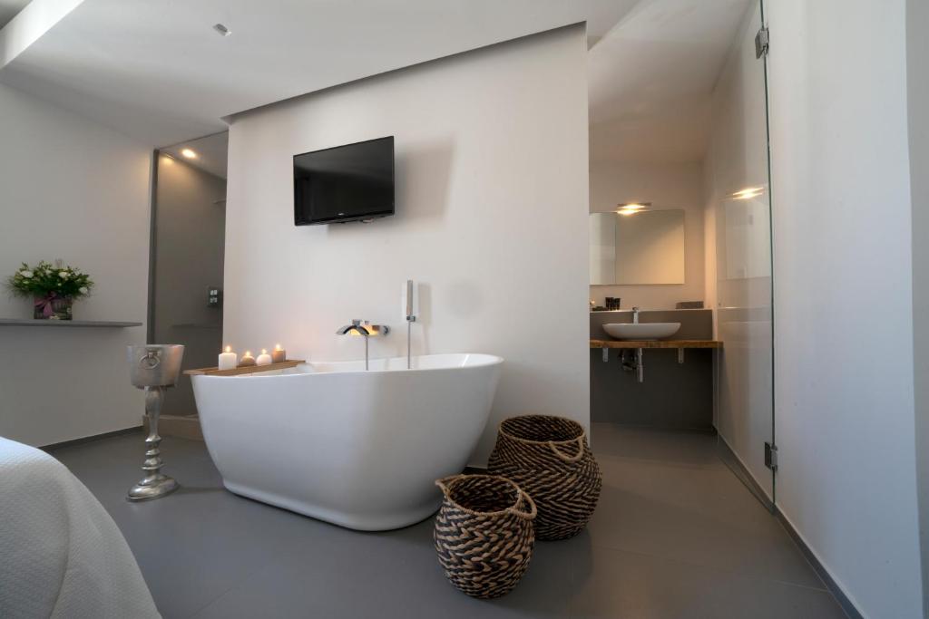 a bathroom with a white tub and a sink at New Dimora Valmar in Polignano a Mare