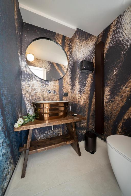 a bathroom with a sink and a mirror at New Dimora Valmar in Polignano a Mare