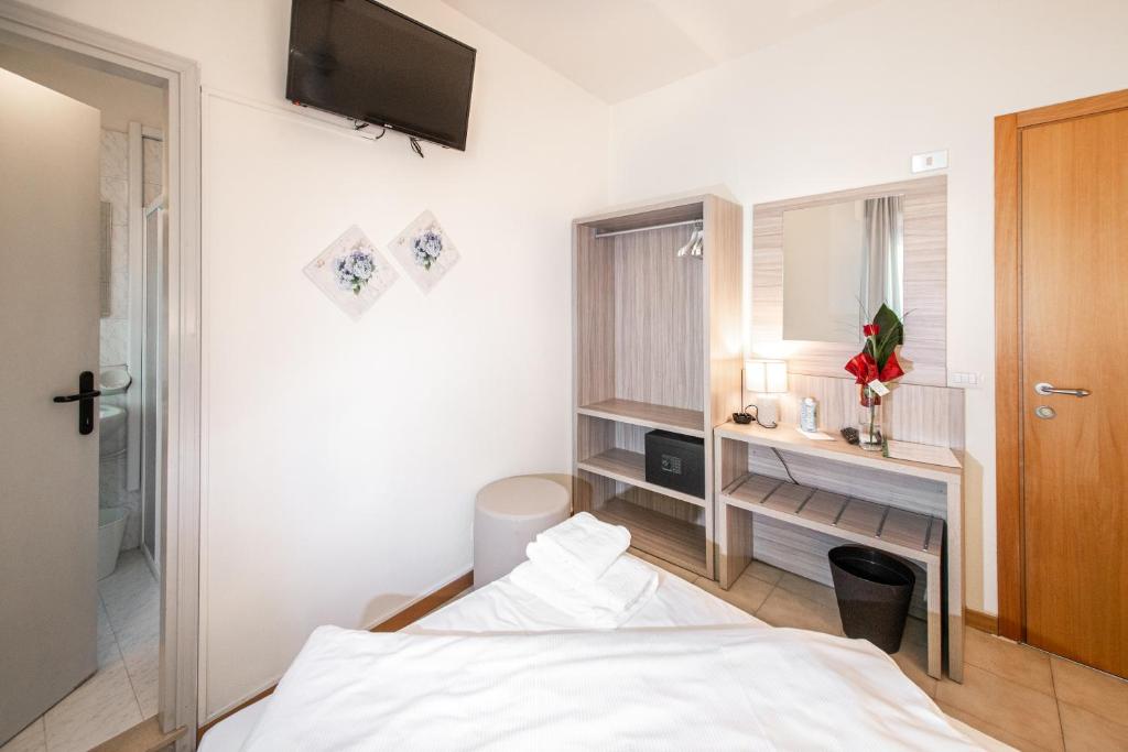 Postel nebo postele na pokoji v ubytování Hotel Menapace