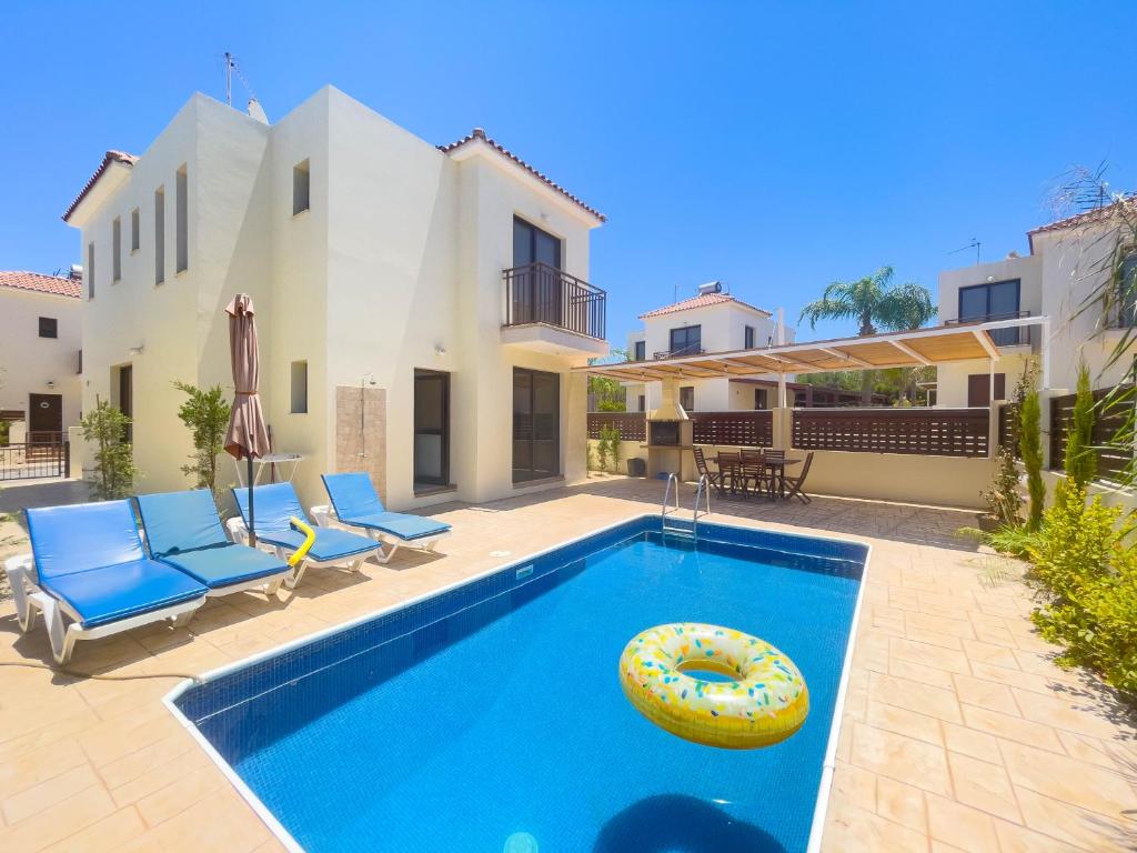 a swimming pool in the backyard of a house at Fotini Villas in Protaras