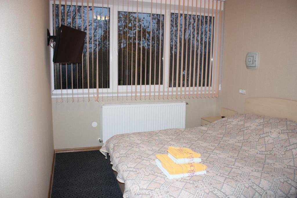 Postel nebo postele na pokoji v ubytování Balvi Hotel
