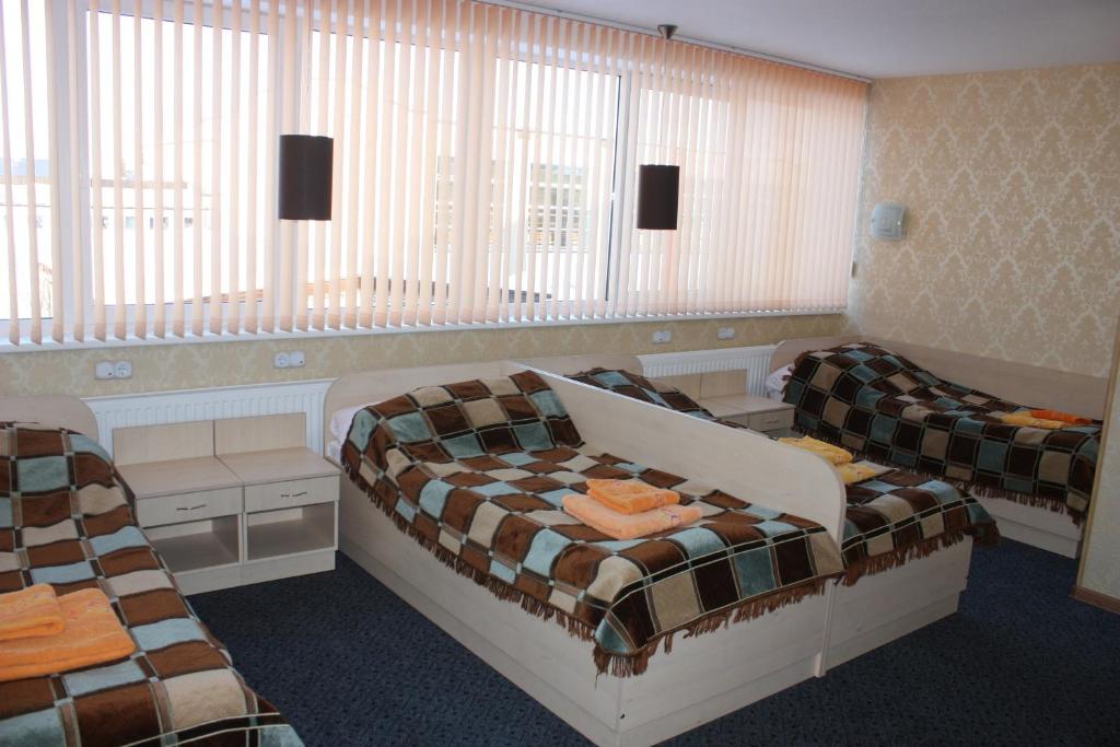 Postel nebo postele na pokoji v ubytování Balvi Hotel