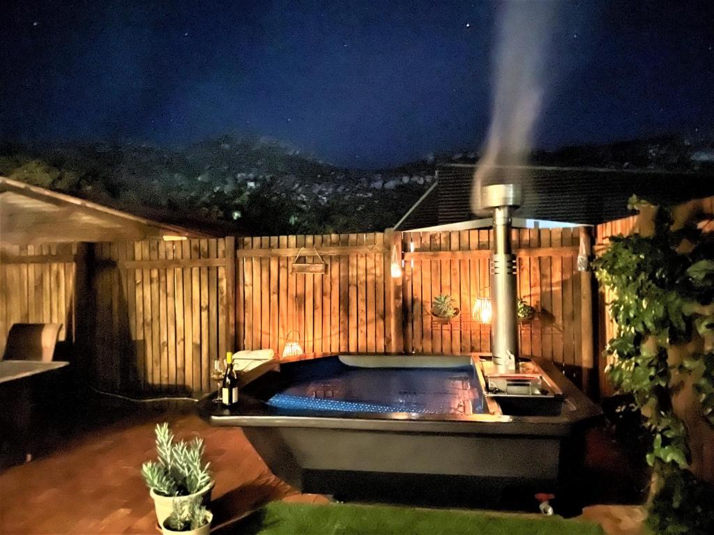 a hot tub in a backyard at night at Naurolukki #1 in Cape Town