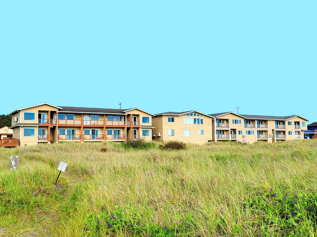 a large building with a grassy field in front of it at Moonstone Beach Motel in Moclips