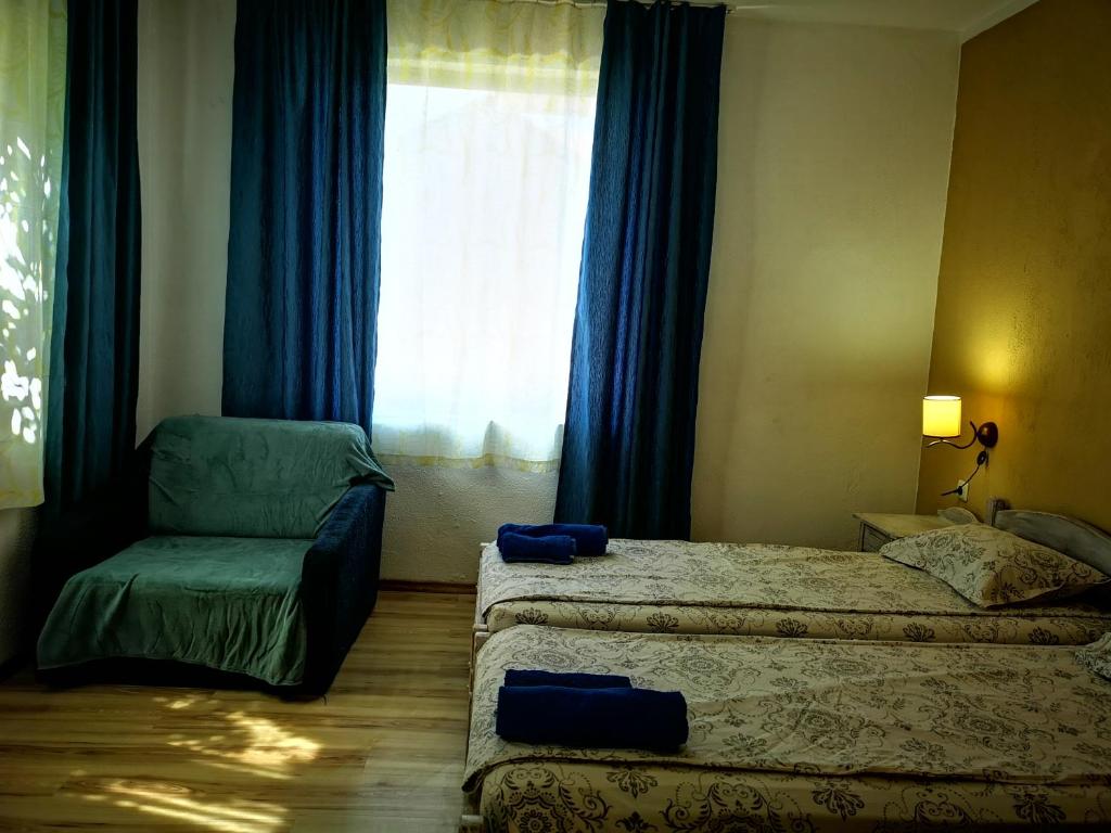 A bed or beds in a room at Paunovi Guest House