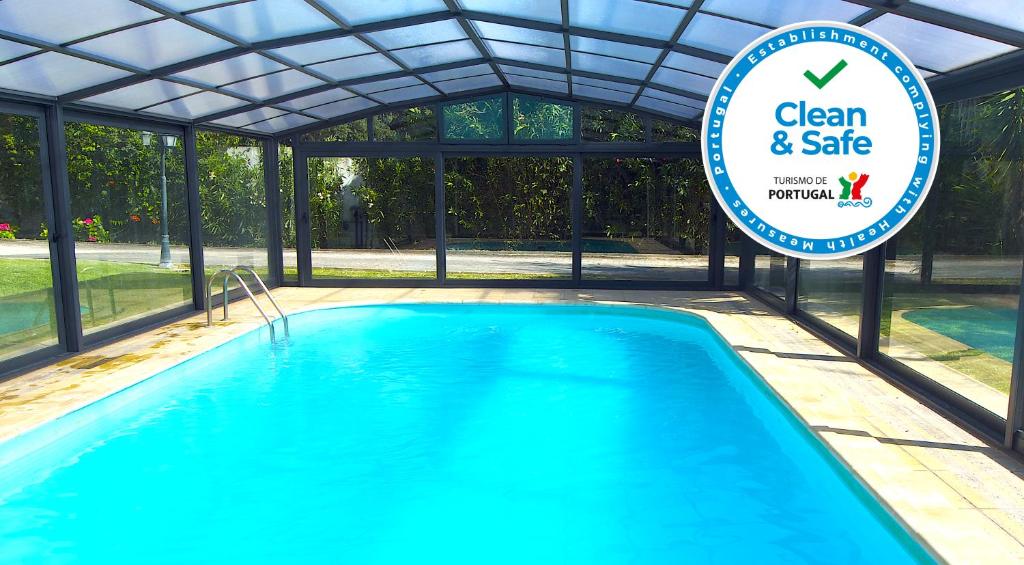 a swimming pool with a sign that says clean and safe at D'Vine - Country house in Cartaxo