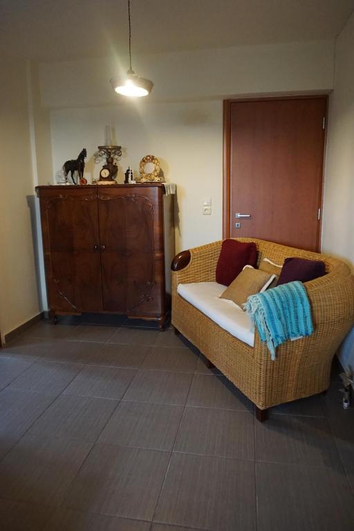 a living room with a couch and a cabinet at Blue Horizon Dream in Thymonia Beach