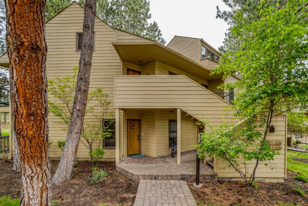 a yellow house with a porch at Ski House 155 in Bend