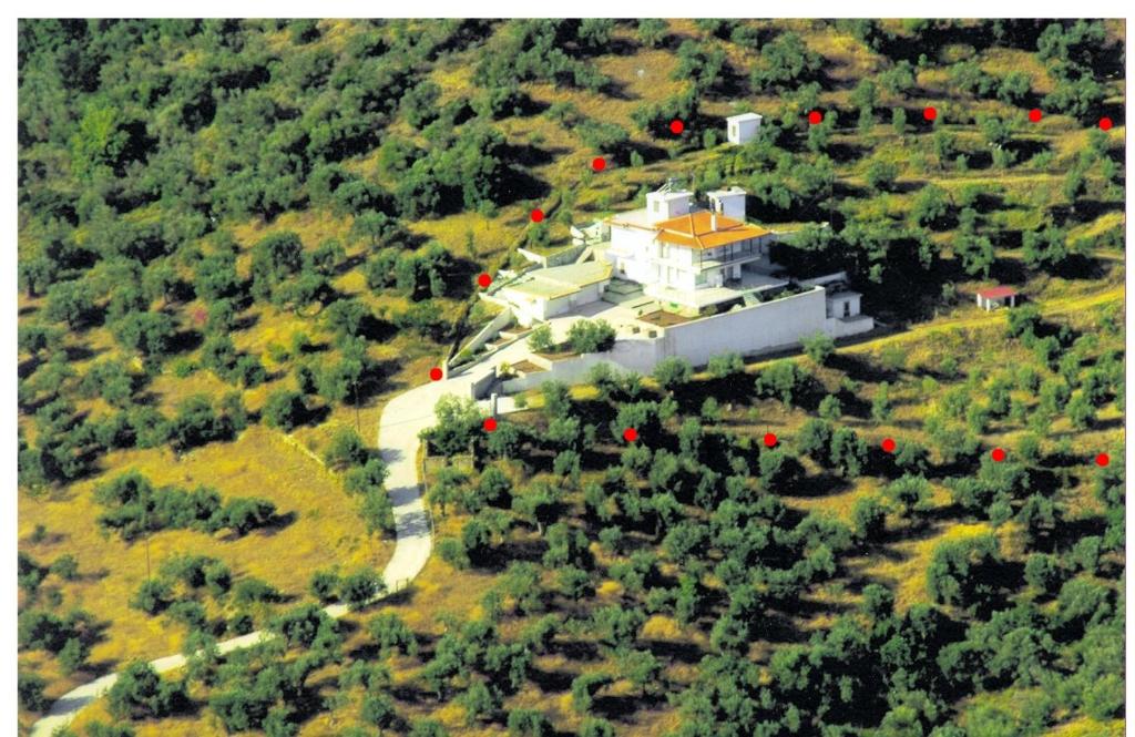 an aerial view of a large white house with a yellow roof at GEORGE'S VILLA in Galatas