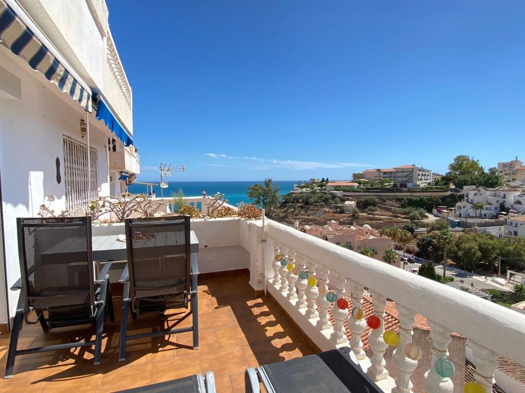 balcón con mesa, sillas y vistas al océano en Litoral Burriana Apartments Casasol, en Nerja