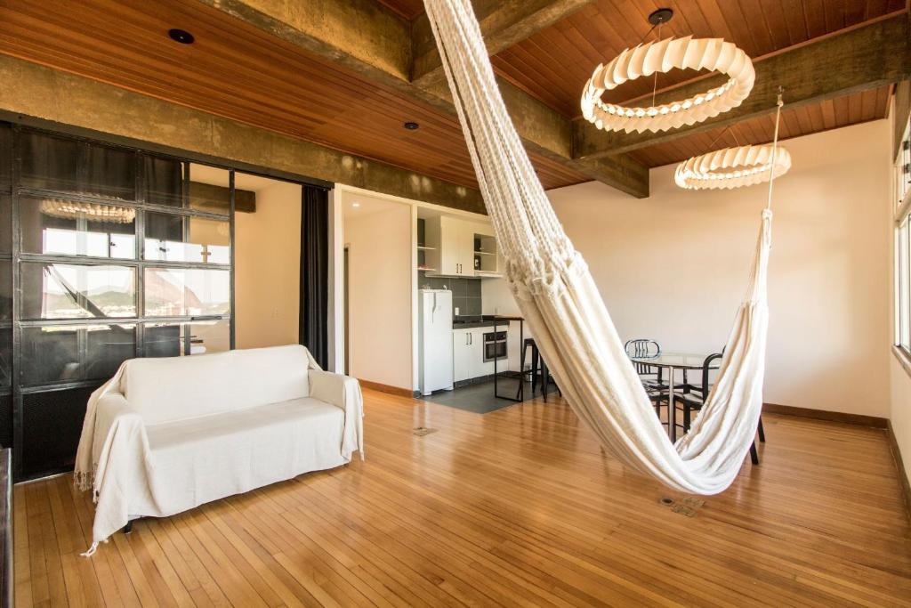 a living room with a hammock hanging from the ceiling at Casa Do Gato Cinzento in Rio de Janeiro
