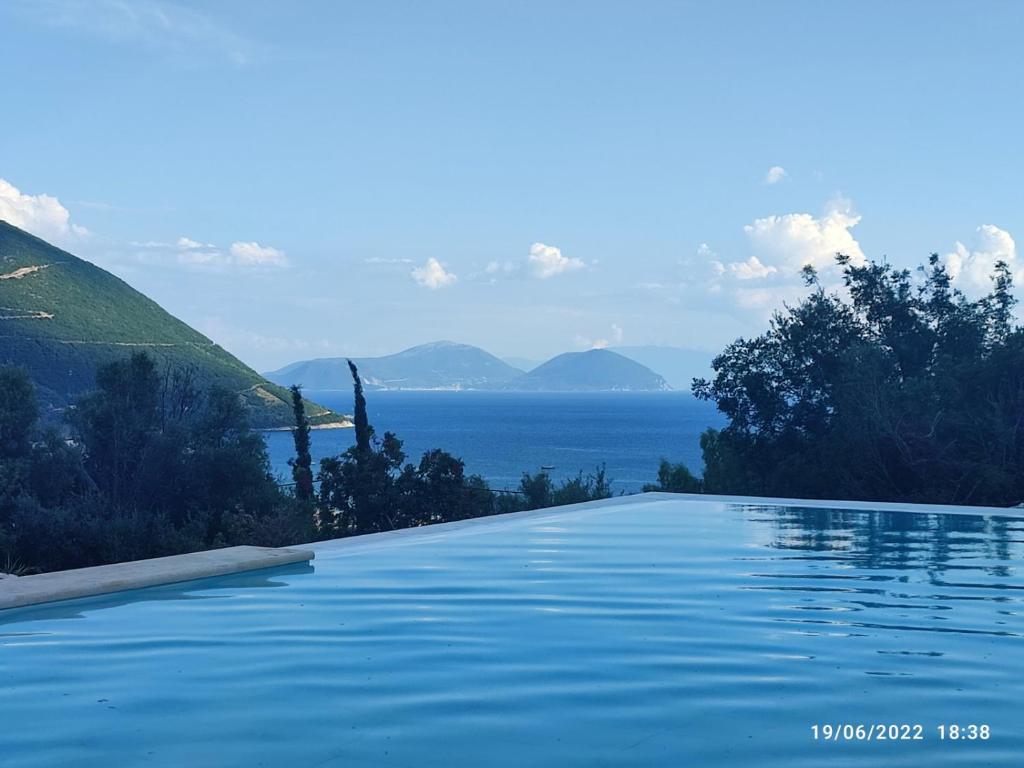 a swimming pool with a view of the water at Calionas Suites in Vasiliki