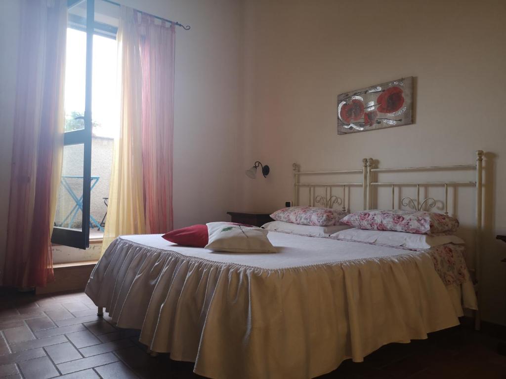 1 dormitorio con 1 cama grande y ventana en Affittacamere Albafiorita en Castiglione dʼOrcia