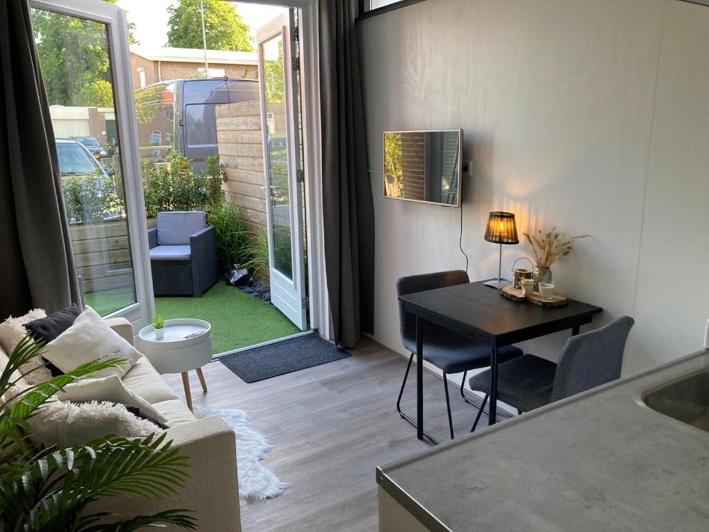 a living room with a table and a dining room at Casa Bianco in Koudekerke