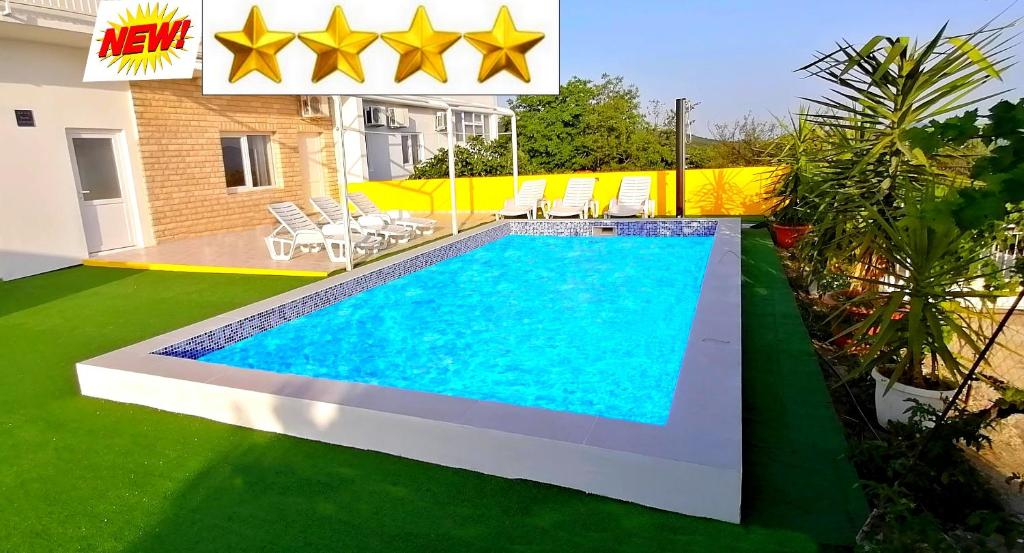 a swimming pool with stars on the side of a house at Apartman Andy in Imotski