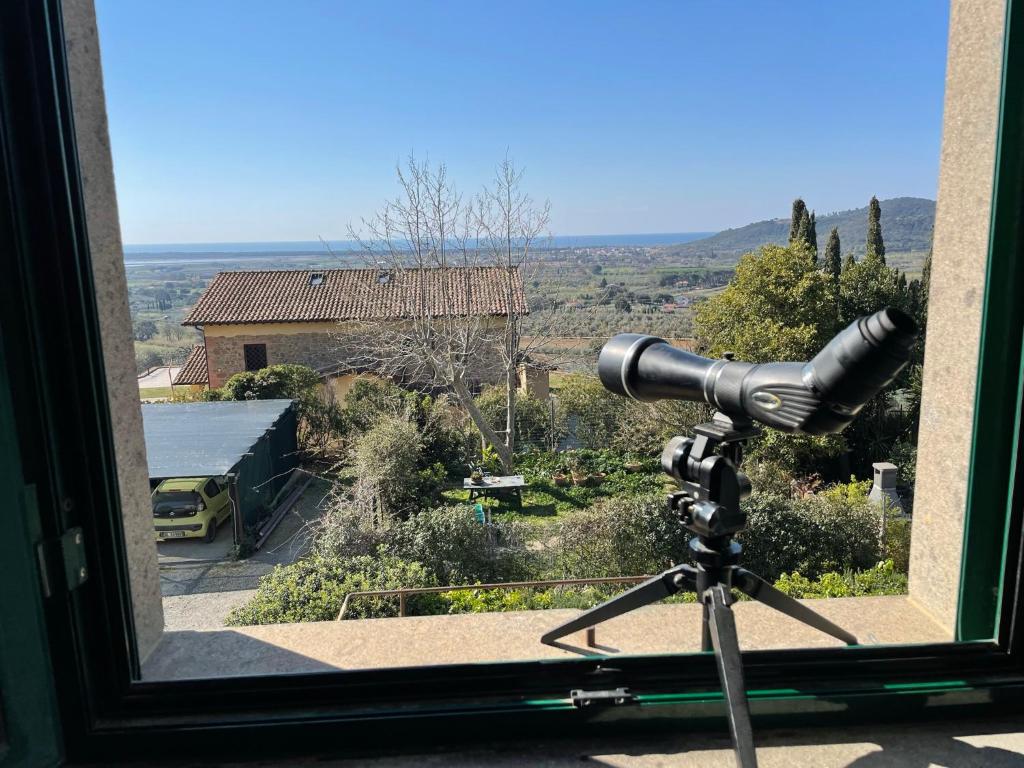 a camera in front of a window with a view at Antica Casa Prile in Castiglione della Pescaia