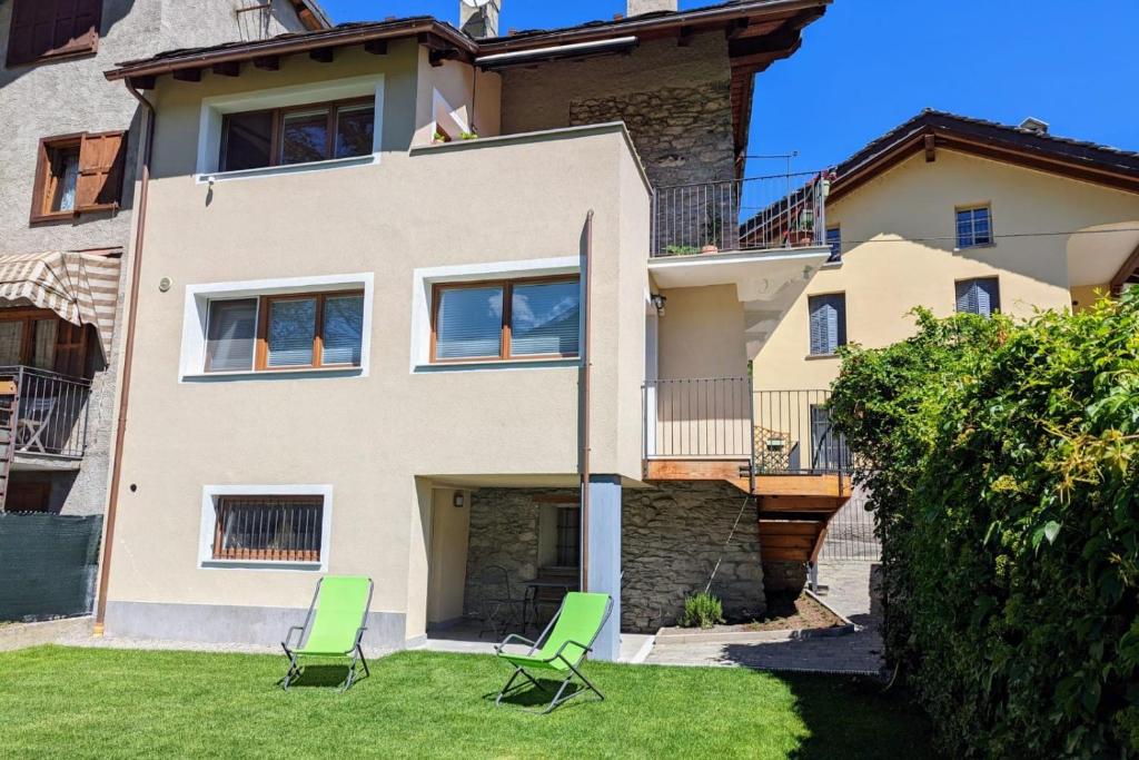 a house with two lawn chairs in front of it at StudiÒ Lalex28 in Aosta