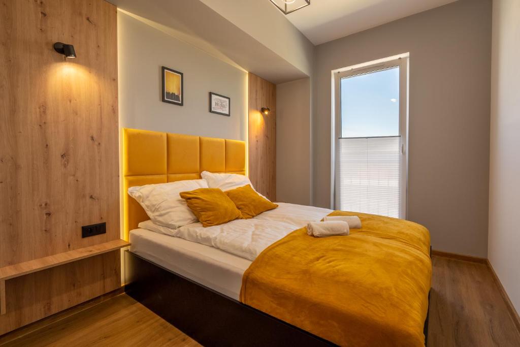 a bedroom with a large bed with a yellow blanket at Apartament No82 Yellow Holiday Home Zator in Zator